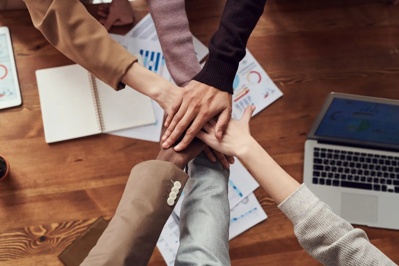 Colleagues' hands joined on the work table